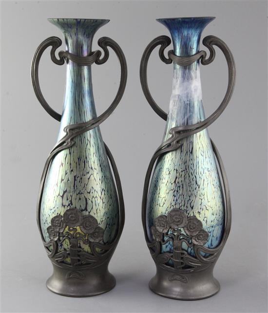 A pair of Loetz style iridescent glass vases, height 31.5cm, one broken, the other with rim chips